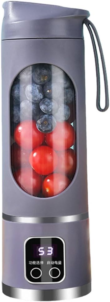 Mini mixeur à jus 450 mL de couleur rose, posé sur un plan de travail avec des fruits frais