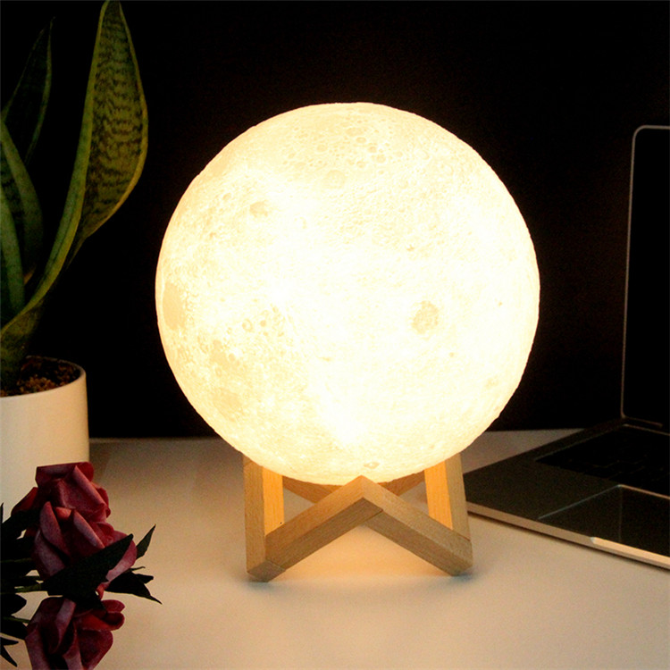 Lampe Lune 3D éteinte, montrant la texture réaliste des cratères, posée sur son support
