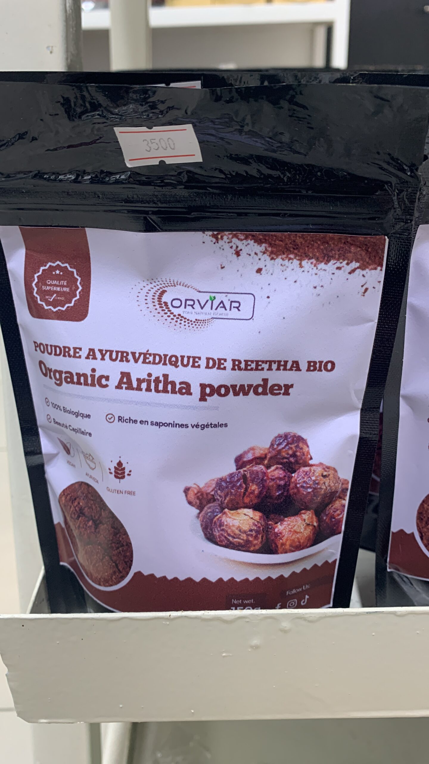 Application de la pâte de soin ayurvédique sur des cheveux, montrant la texture onctueuse de la préparation